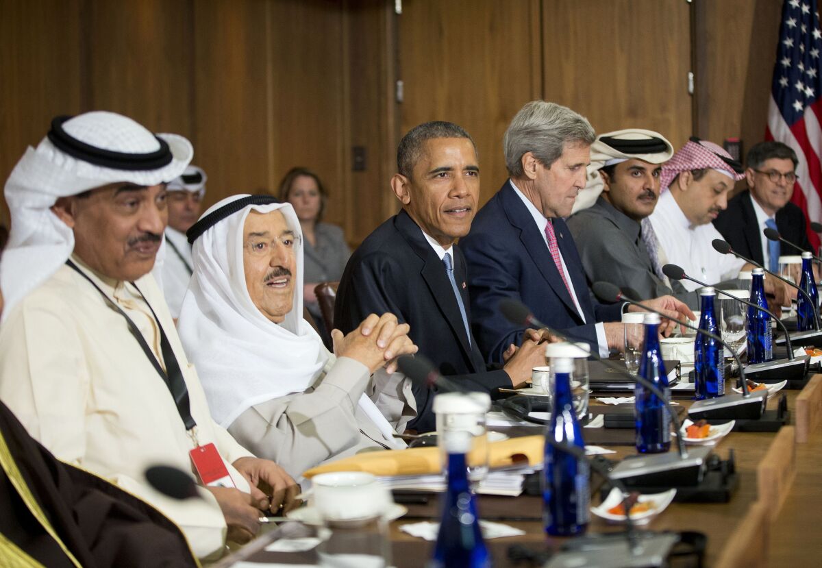 President Obama is flanked by Kuwait's emir, Sheik Sabah al Ahmed al Jabbar al Sabah, and Secretary of State John F. Kerry during a summit with Gulf Cooperation Council leaders at the presidential retreat at Camp David in Maryland on Thursday.