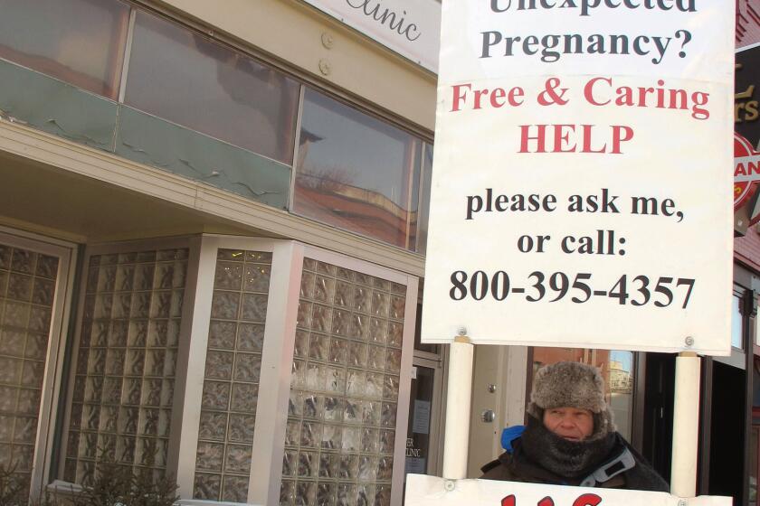Protesters outside the Red River Valley Women's Clinic in Fargo, the only abortion provider in North Dakota. A federal judge ruled Wednesday that the state's ban on abortions after 6 weeks is unconstitutional.