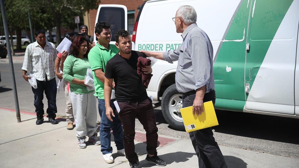 Ruben Garcia, right, director of the Annunciation House shelter, greets migrant parents, all of whom were separated from their children by U.S Customs and Border Patrol, as they arrive at his facility in El Paso on June. 24, 2018.
