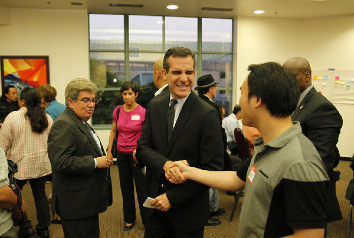 Mayor-elect Eric Garcetti greets participants at a community meeting inside the Grand Salon at Cal State Northridge.