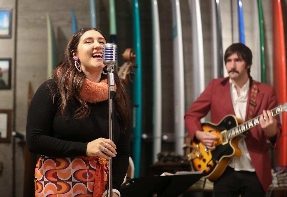 Celena Marie and Dylan DelPizzo-Howell of the band Moonshine perform at Hobie Surf Shop during Hospitality Night.