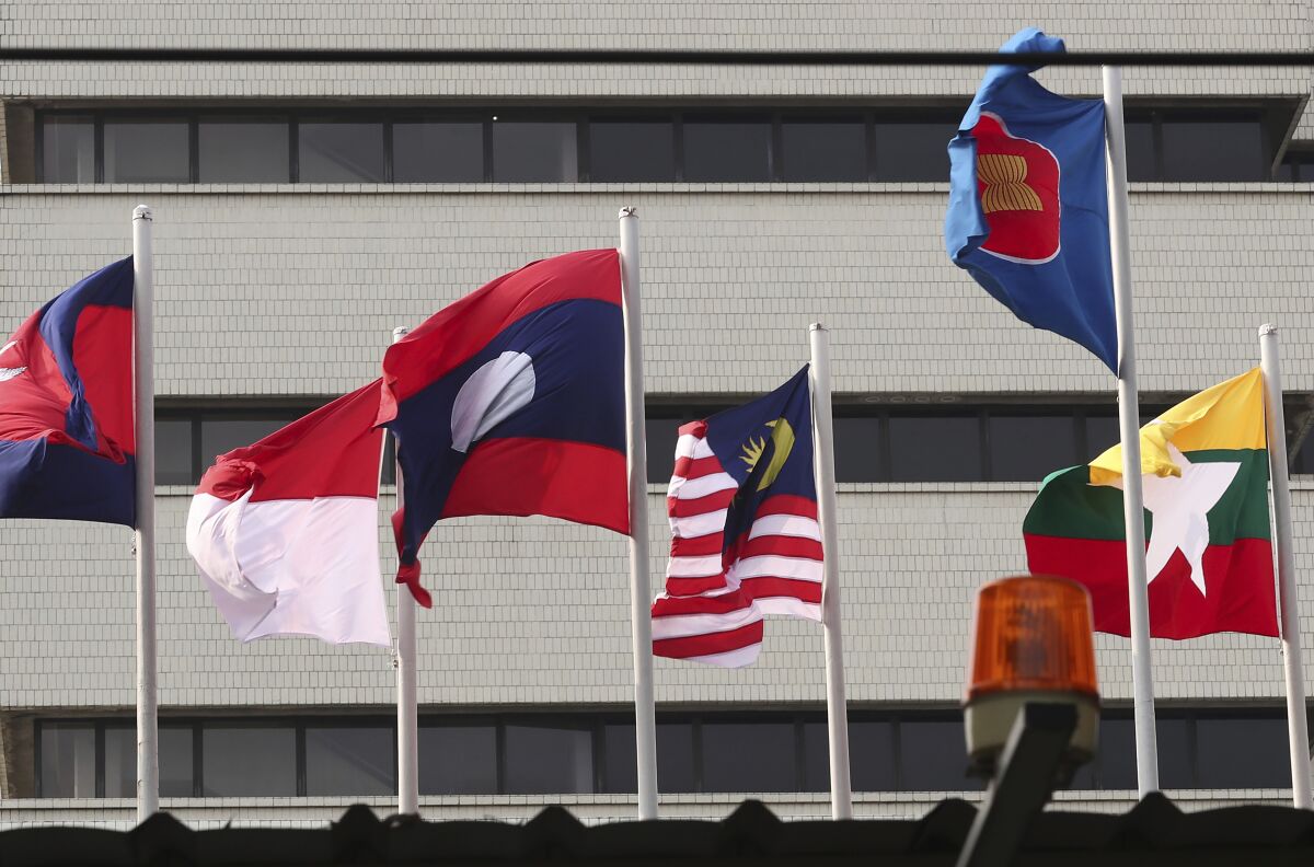 In this April 22, 2021, file photo, flags of some of the ASEAN member countries fly at the ASEAN Secretariat in Jakarta, Indonesia. Southeast Asia’s top diplomats were meeting Monday, Aug. 2, 2021, to appoint a special envoy to help deal with the political crisis and violence gripping Myanmar and finalize an emergency plan to help control a coronavirus outbreak that many fear is spiraling out of control in the military-ruled nation. (AP Photo/Tatan Syuflana, File)