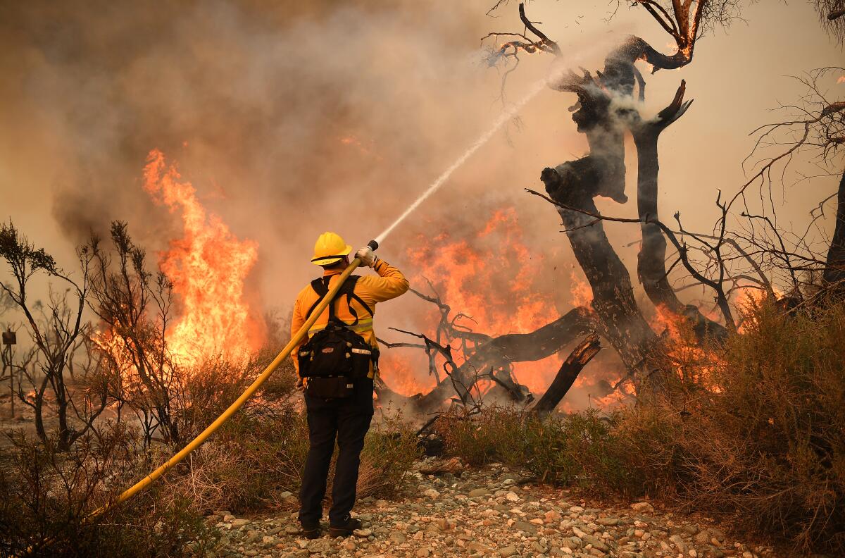 A firefighter battles the Bobcat Fire in 2020.