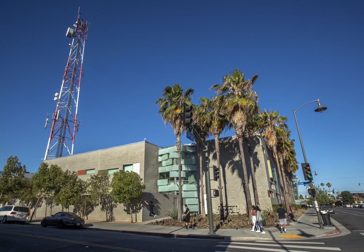 Decorative panels on the exterior structure of the LAPD Hollenbeck Station with a tall broadcast tower next to it