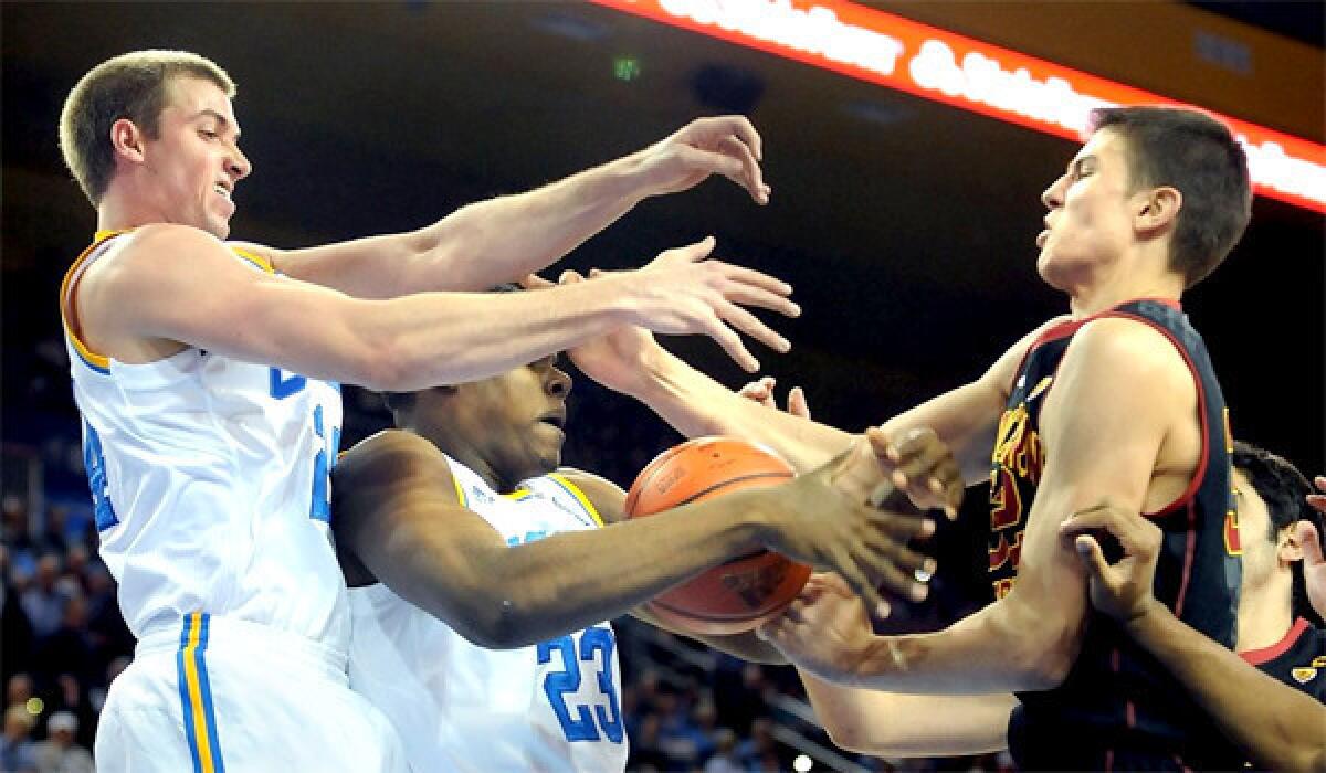 UCLA's Travis Wear, left, and Tony Parker, center, battle for a rebound with USC's Nikola Jovanovic during the Bruins' 107-73 victory over the Trojans in their first meeting of the season.