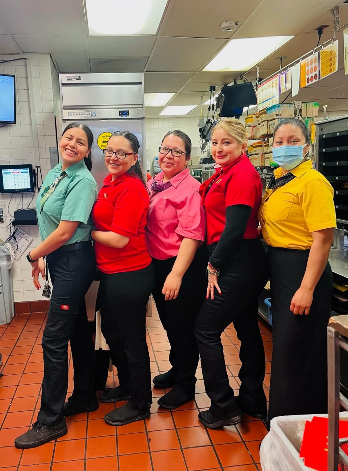 Elizabeth Machado, second from left, in uniform with her team at McDonald’s in Westminster.