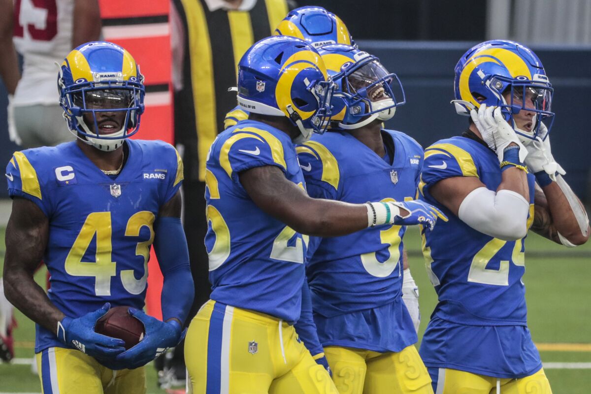 Rams cornerback Darious Williams grimaces walking off the field with his teammates.