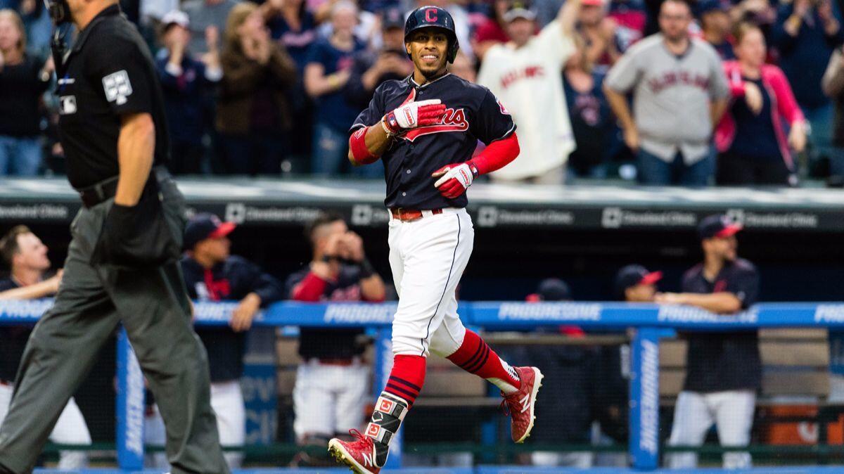 Cleveland Indians' Francisco Lindor (12) celebrates as he rounds the bases on a solo home run during the first inning against the Detroit Tigers on Tuesday.