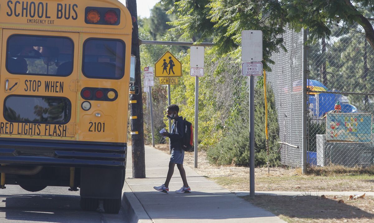 A student boards the bus at Lafayette Elementary School in San Diego in October