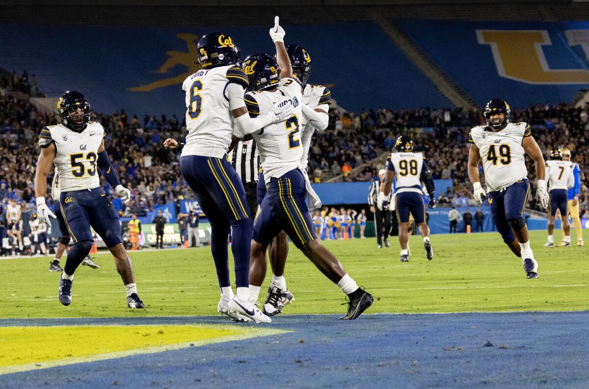 Members of the Cal football team celebrate an interception against UCLA at the Rose Bowl in Pasadena on Nov. 25. 
