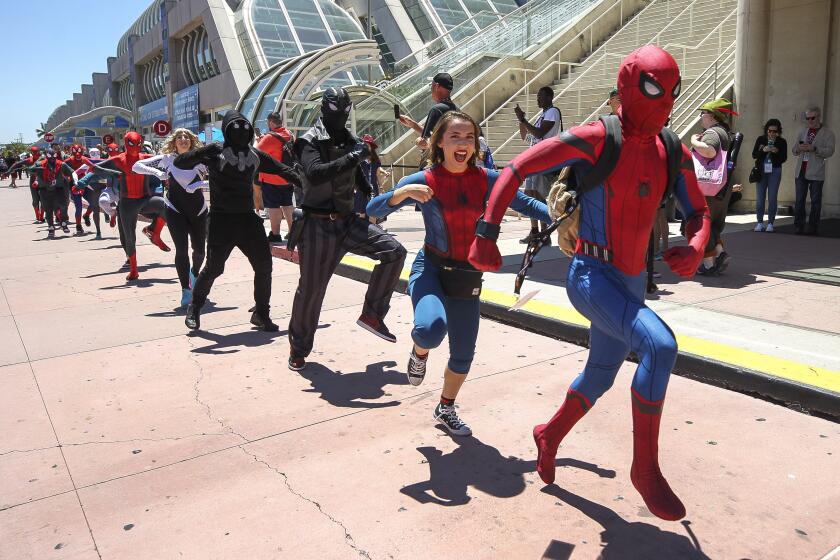 People wearing Spider-Man costumes dance in front of the San Diego Convention Center for a YouTube video during Comic-Con International on Saturday, July 20, 2019 in San Diego, California.