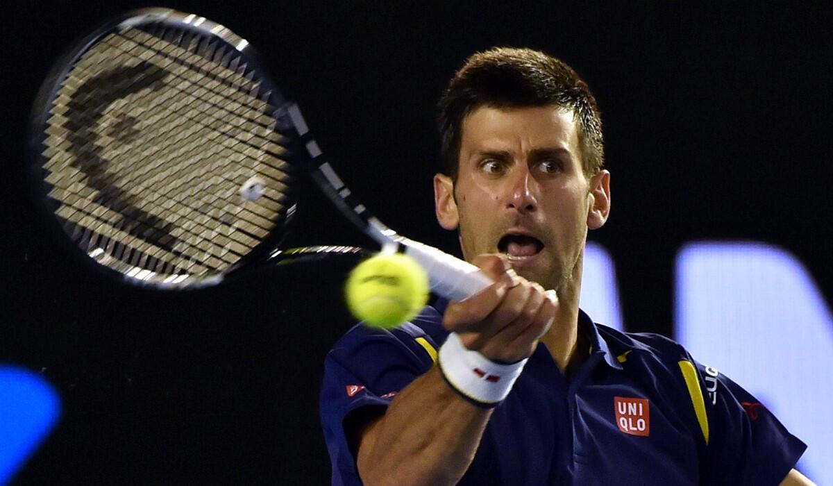Novak Djokovic hits a return during his men's singles semi-final match against Roger Federer in 2016 Australian Open on Thursday.