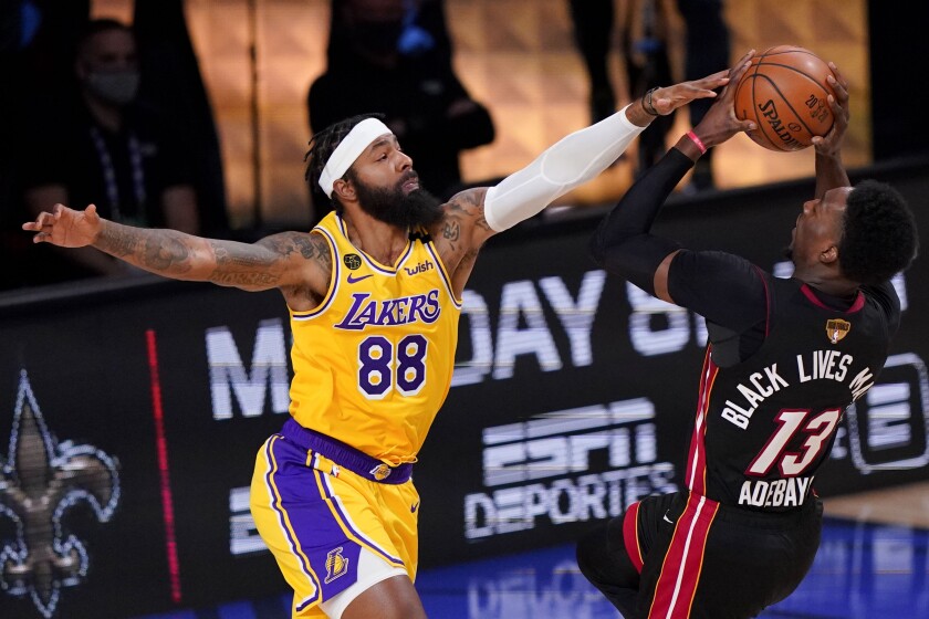 Los Angeles Lakers forward Markieff Morris, left, blocks a shot by Miami Heat forward Bam Adebayo.