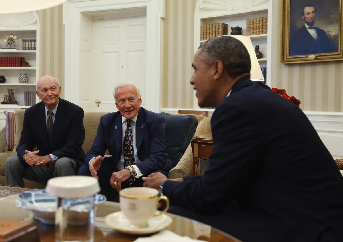 President Obama meets in the Oval Office with Michael Collins, left, and Buzz Aldrin, the surviving members of the Apollo 11 mission.