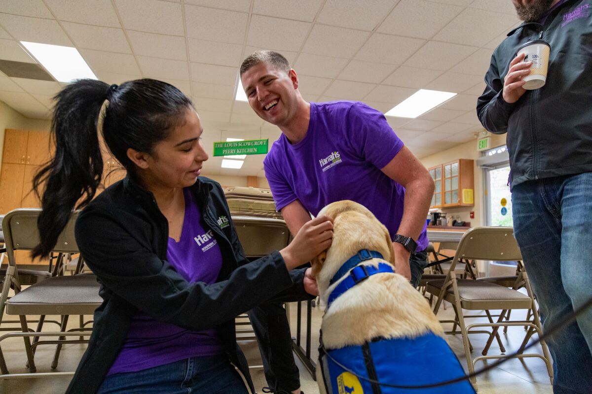 Harrah's SoCal team members bond with a pup from Canine Companions, an organization helped by the casino.