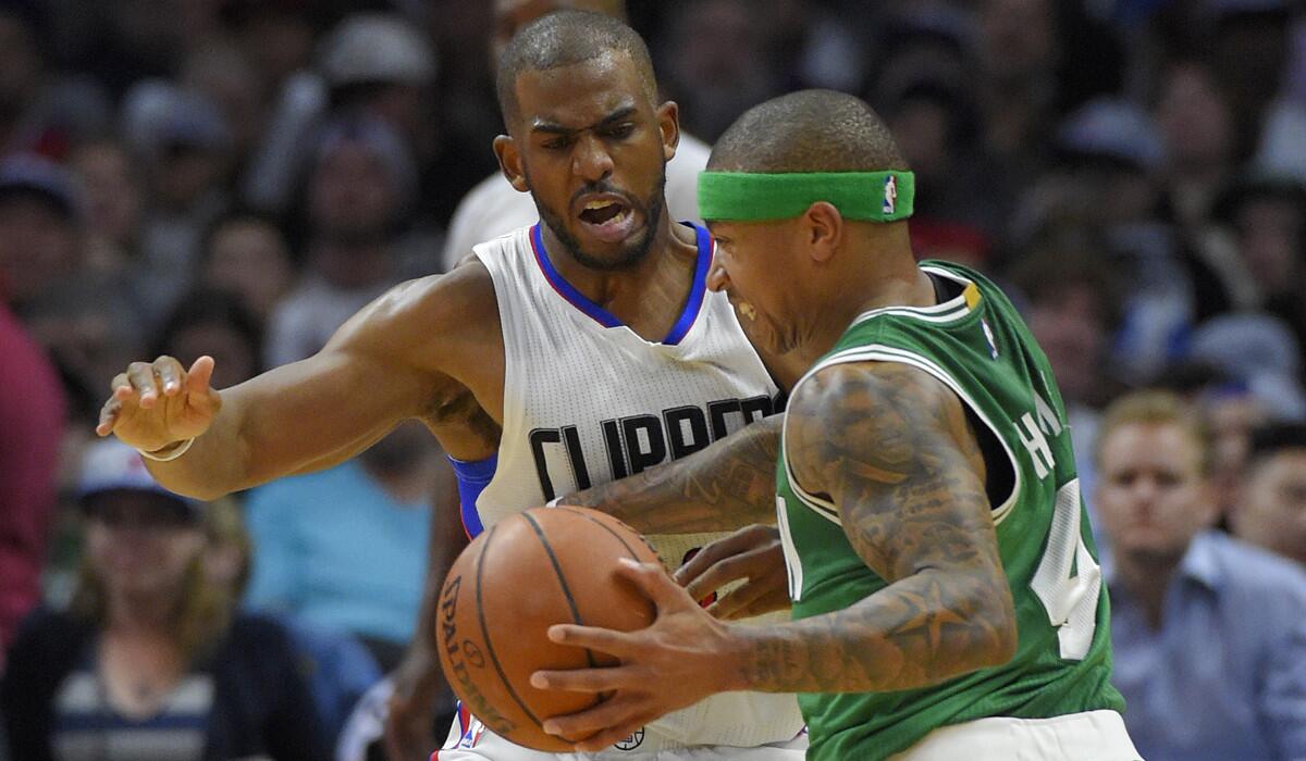Boston Celtics guard Isaiah Thomas, right, drives against Los Angeles Clippers guard Chris Paul during the second half on Monday.
