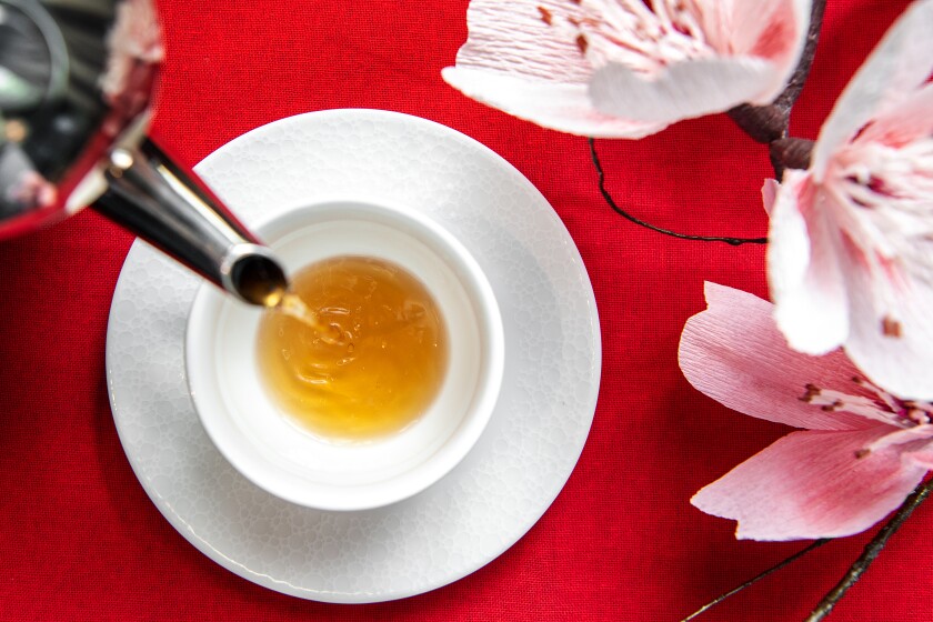 An overhead photo of tea being poured atop a red table cloth at Le Meridien Hotel's Lunar New Year high tea.