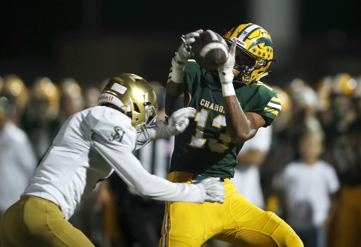 Edison's Cole Koffler does not complete the catch after getting hit by San Juan Hills' James Gaines during the first half of a nonleague game at Huntington Beach High on Friday. Gaines was called for a penalty.