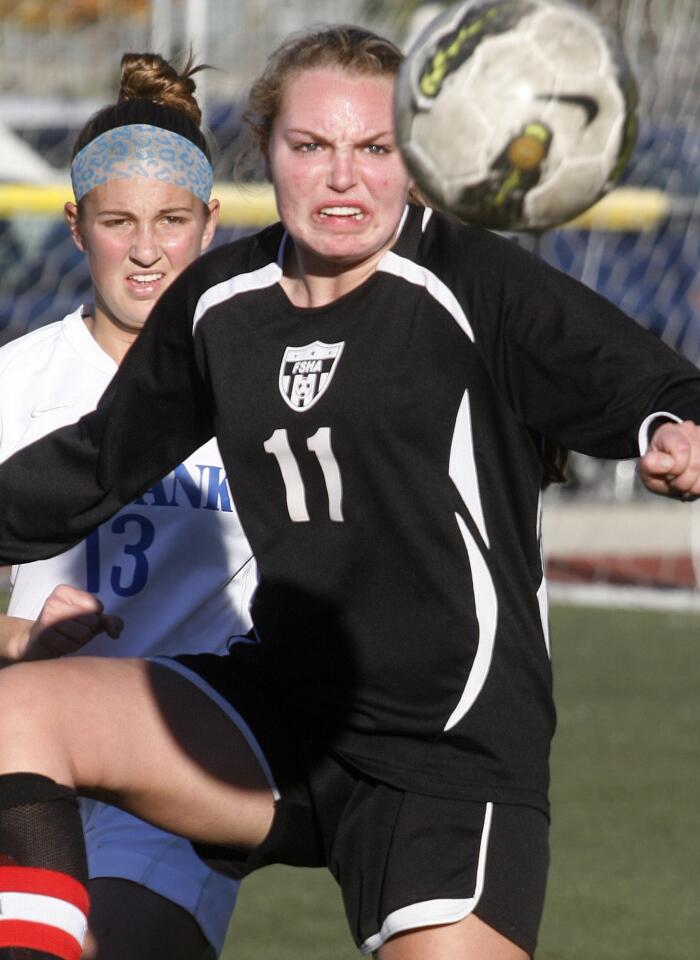 Sacred Heart's Hailey James wins control of the ball against Burbank's Natalie Muller in the second half in a girls' soccer match at the Los Tacos at the Glendale Sports Complex on Thursday, December 27, 2012. Sacred Heart won the match 3-0.