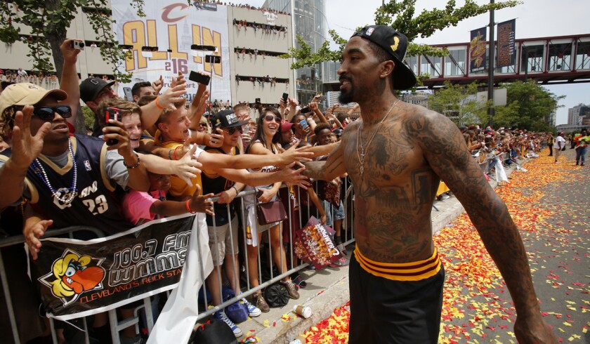 The Cleveland Cavaliers' J.R. Smith greets fans before the start of a parade celebrating the team's NBA championship in downtown Cleveland on Wednesday.