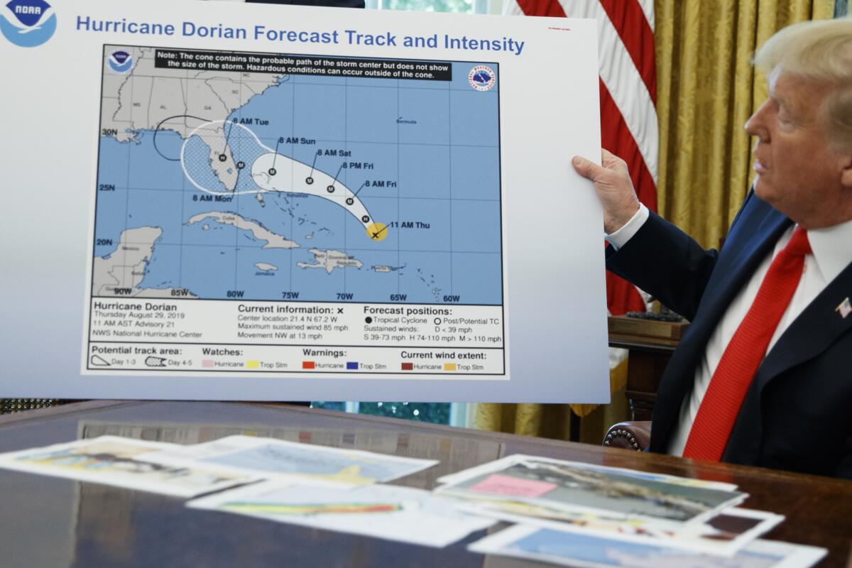 President Trump holds a chart after receiving a briefing on Hurricane Dorian.