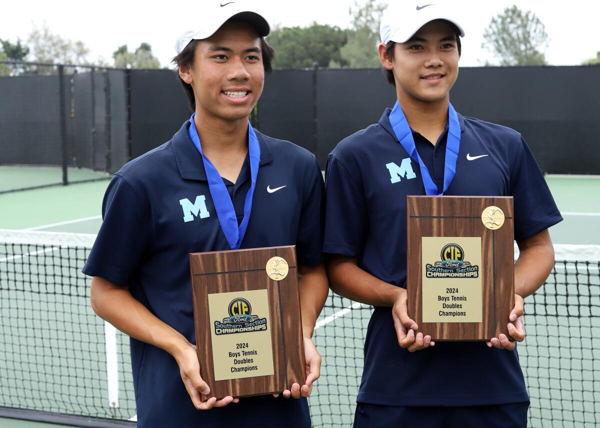 Marina High School's David Tran, left, and Trevor Nguyen hold their CIF doubles championship plaques.