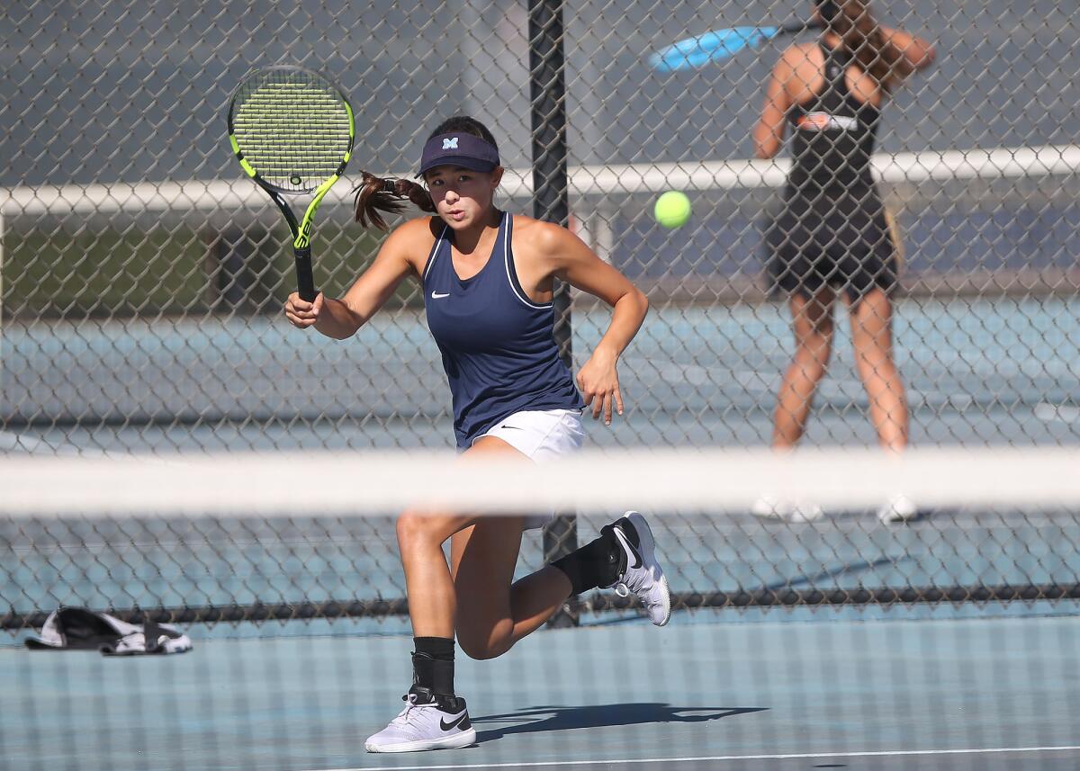 Marina's Mika Ikemori runs down a forehand against Huntington Beach's Cindy Huynh in the singles semifinals of the Wave League tournament on Thursday at Marina High.