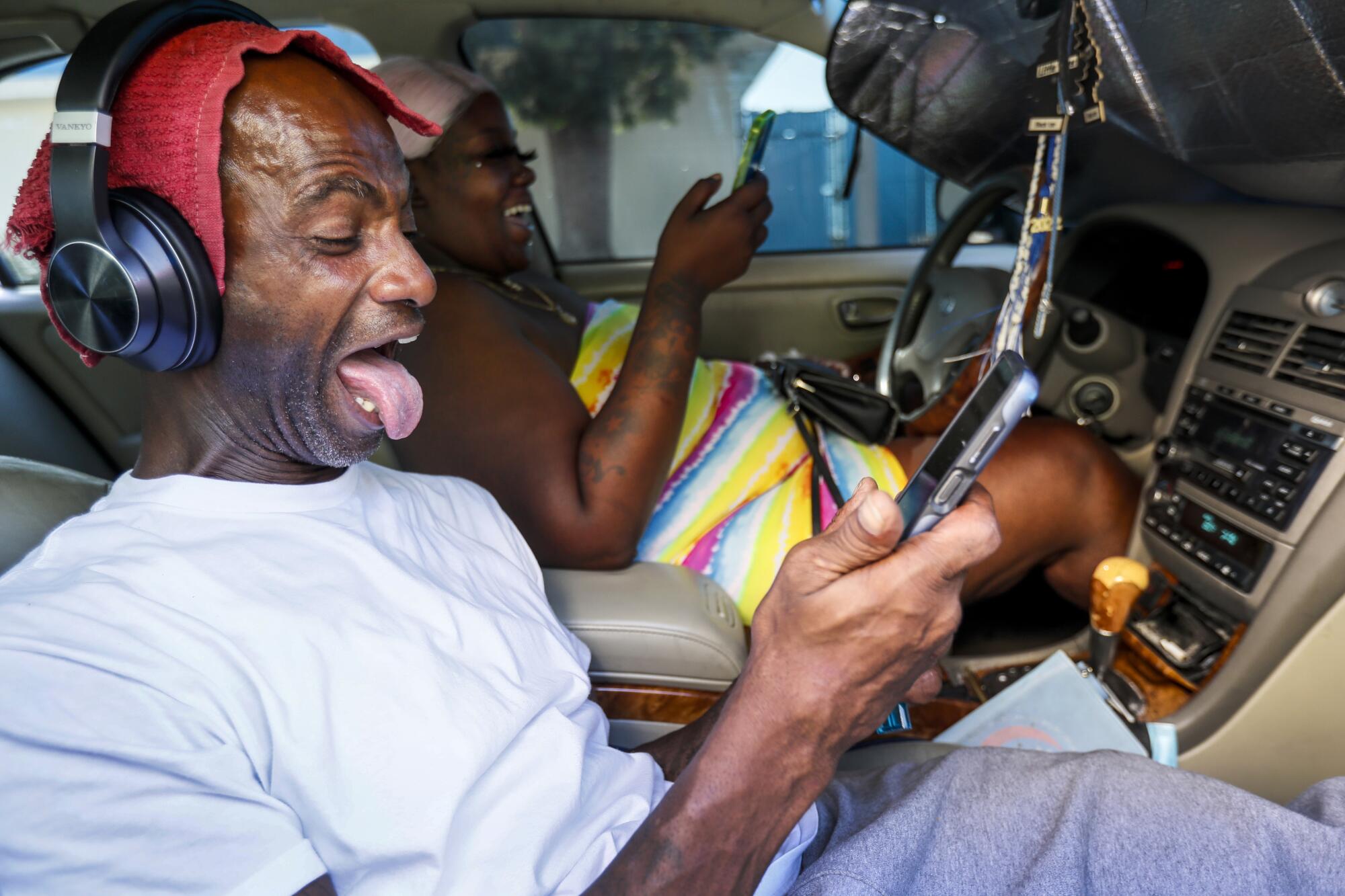 Donald Winston shares a laugh with Shalisa White outside the homeless shelter where he has lived since December.