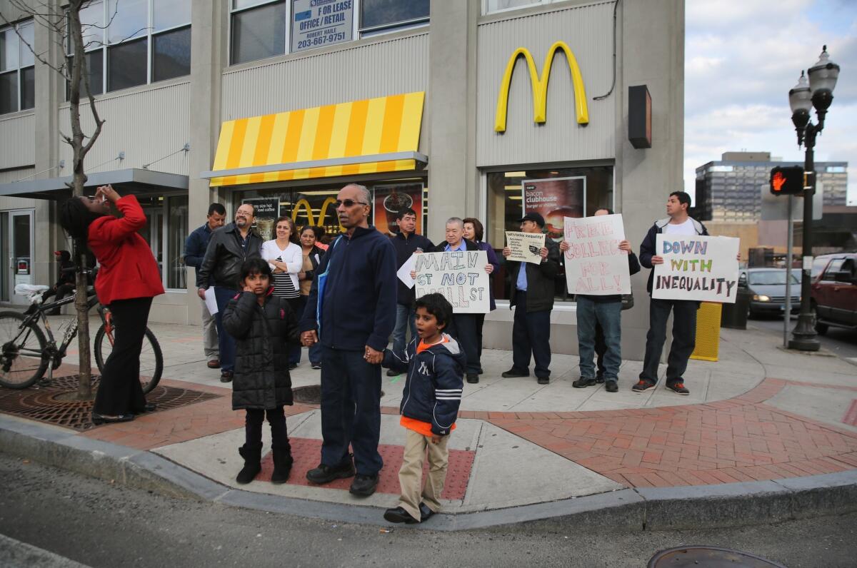 Activists rally for higher wages outside a McDonald's restaurant in Stamford, Conn.