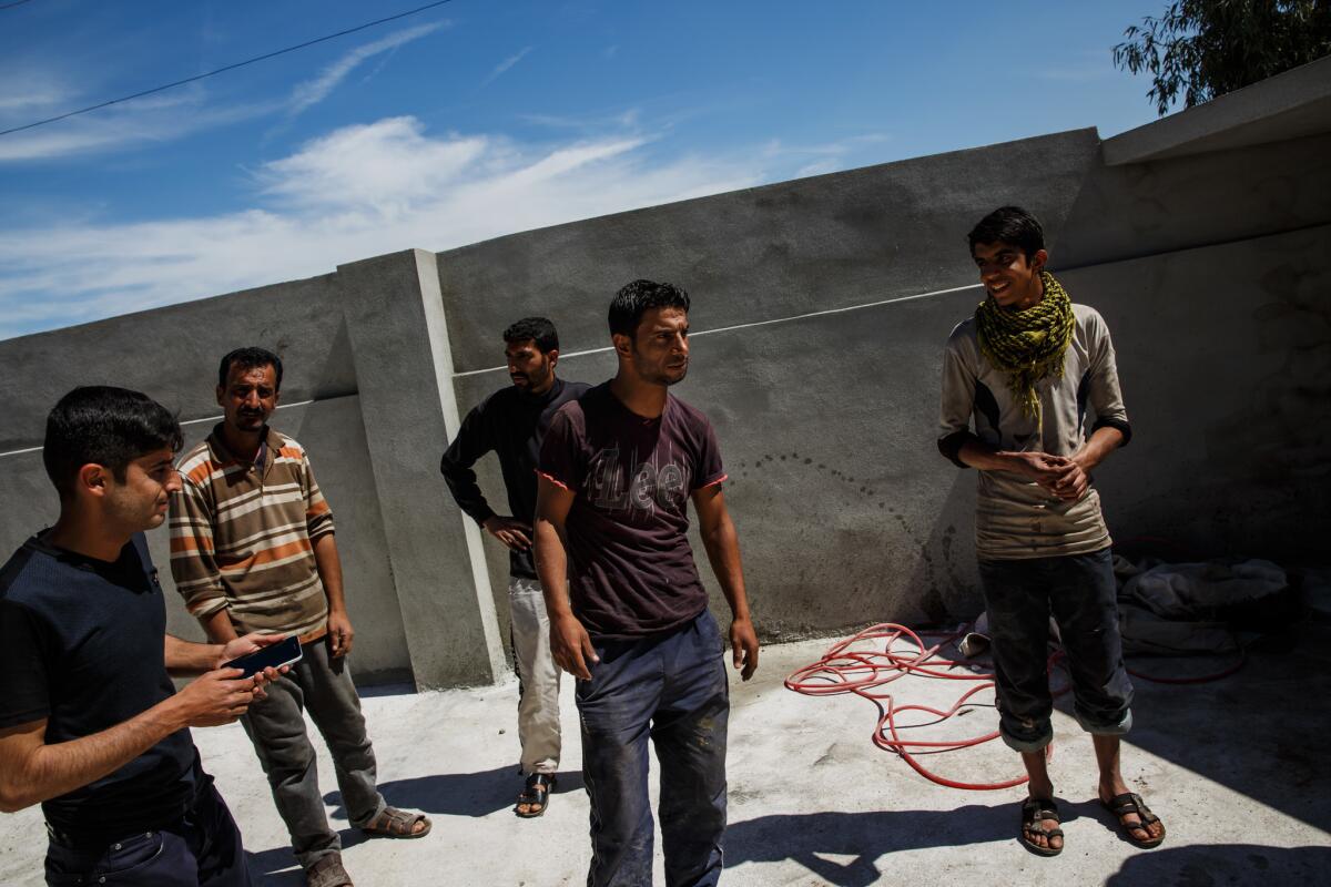 Raed Mohammed Hasan, 30, center, said he lost 11 neighbors and relatives, including his 11-month-old daughter, Rania, in an airstrike in east Mosul on Jan. 21. Coalition records show a strike was carried out in Mosul that day, but officials say it is not being investigated for civilian deaths. He is still rebuilding his home.