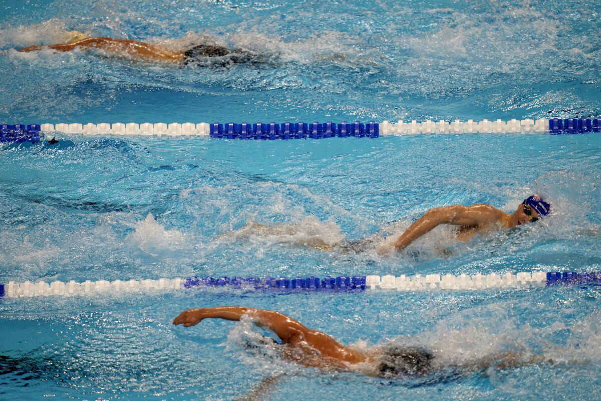FILE - Swimmers compete during the U.S. Olympic Swim Trials in Omaha, Neb., on June 20, 2021. USA Swimming has added technology to its abuse-reporting systems that will allow better communication between investigators and reporters who want to remain anonymous. On Monday, Aug. 8, 2022, the organization announced a deal with RealResponse, which is international Safe Sport Day. (AP Photo/Jeff Roberson, File)