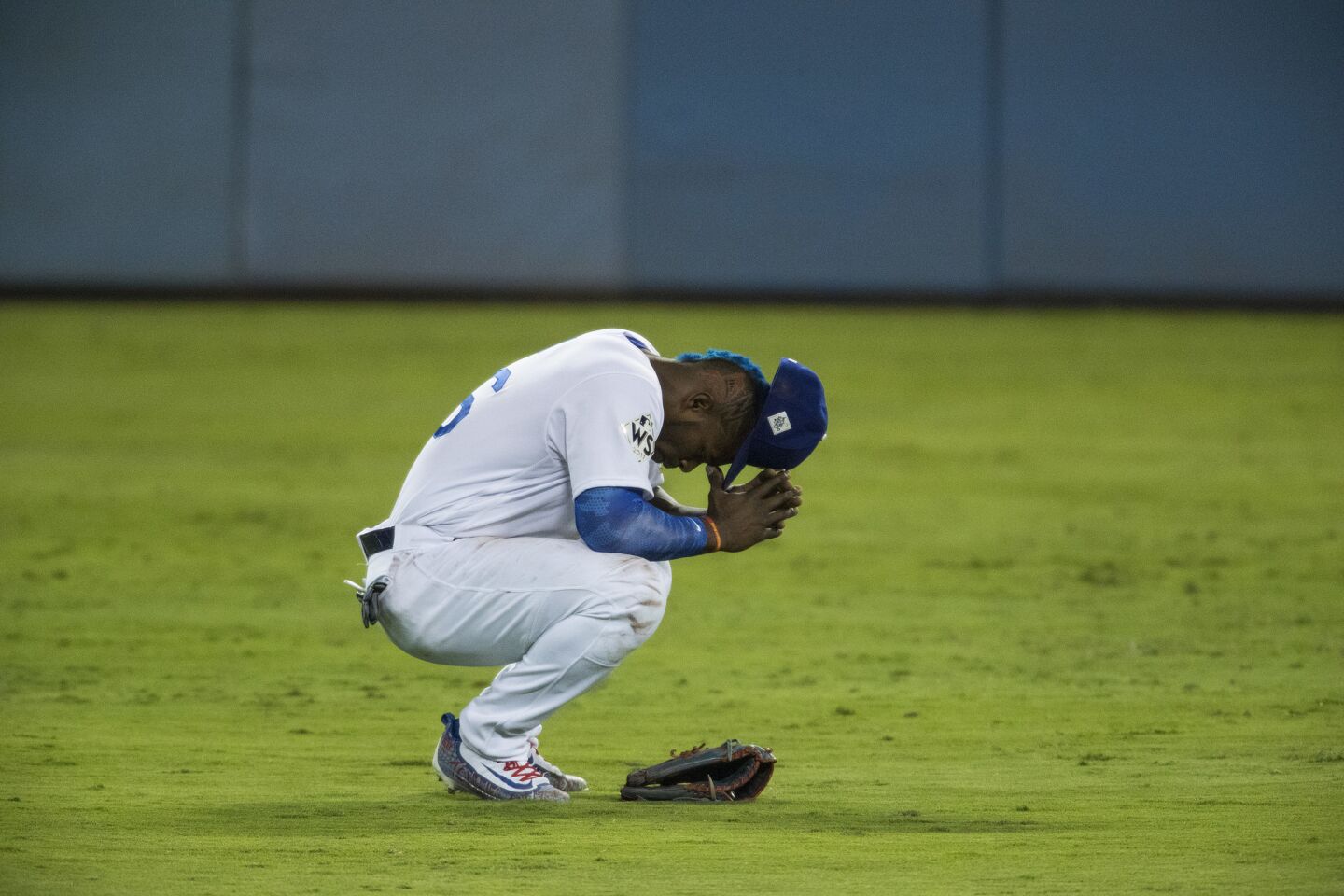 Yasiel Puig sits with his head in his hands after not being able to catch what turned into a ground-rule double off the bat of Astros third baseman Alex Bregman during the seventh inning.