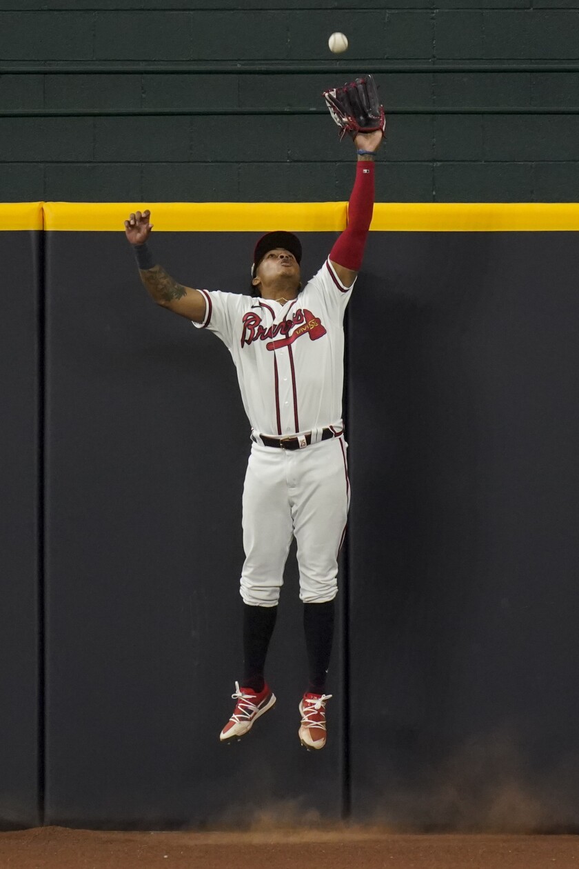 Atlanta Braves center fielder Cristian Pache robs the Dodgers' Max Muncy of a home run.