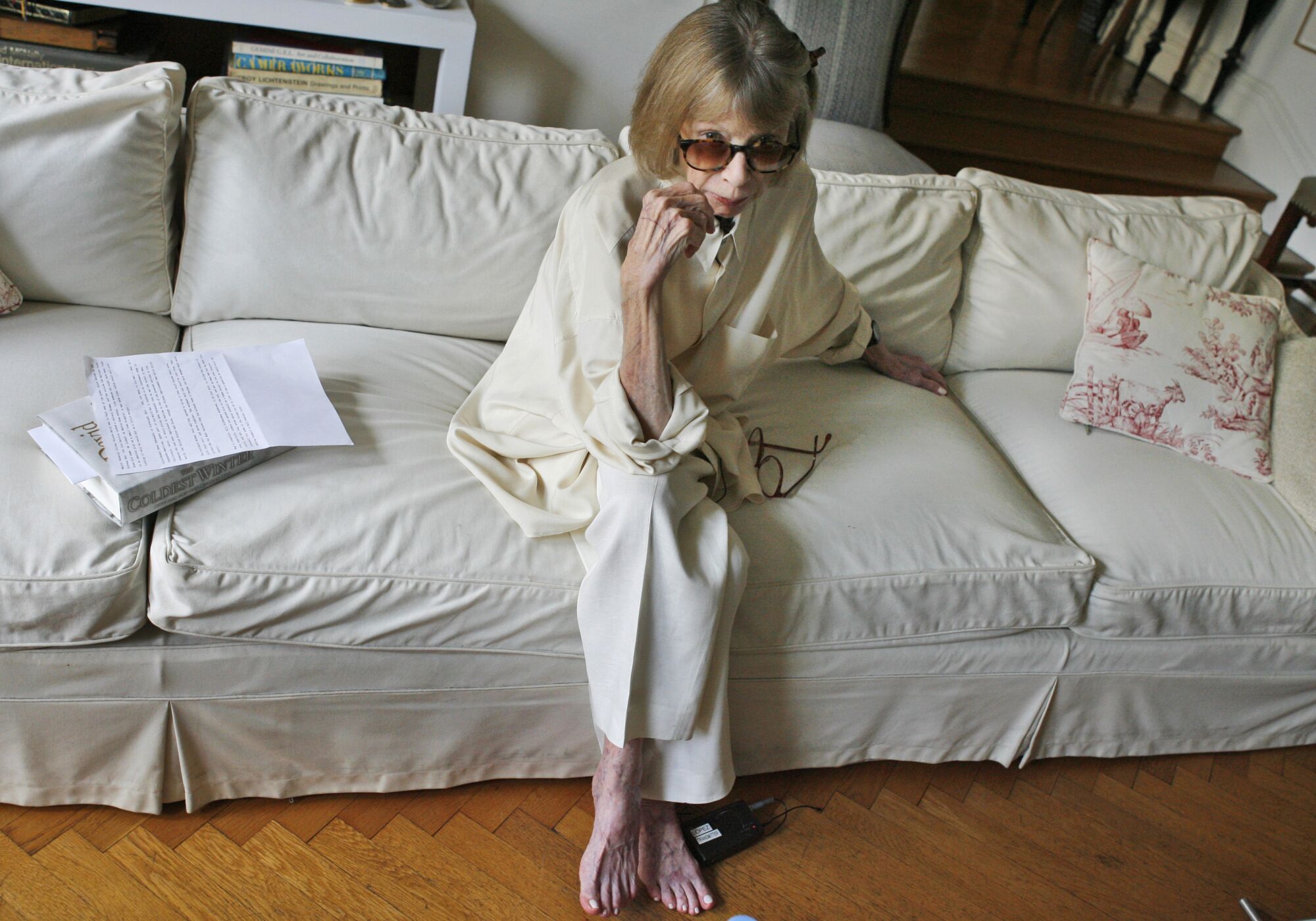 Joan Didion sits on a couch in her apartment in 2007.