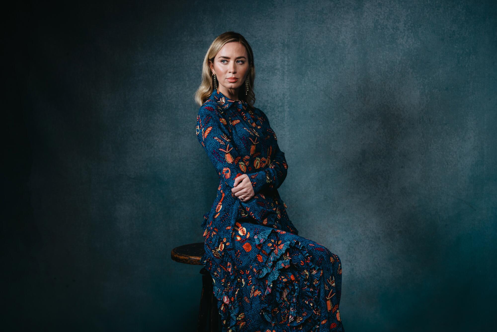 Emily Blunt folds her arms in front of her for a portrait.
