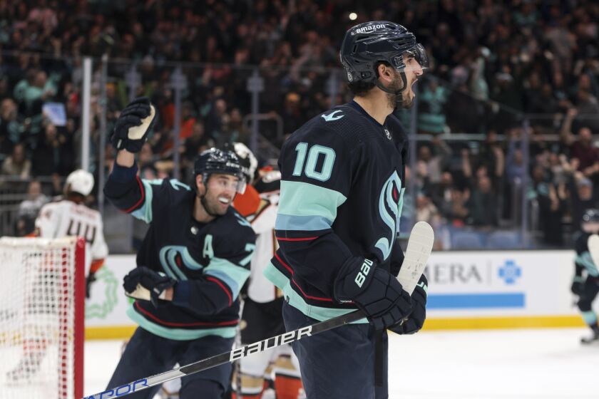 Seattle Kraken center Matty Beniers (10) and right wing Jordan Eberle, left, celebrate after Beniers' goal during the first period of an NHL hockey game against the Anaheim Ducks, Thursday, March 30, 2023, in Seattle. (AP Photo/Jason Redmond)