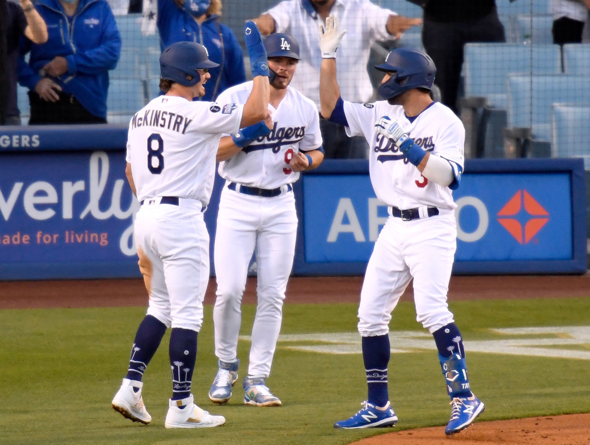 The Dodgers' Chris Taylor, right, celebrates his three-run homer with Zach McKinstry, left, and Gavin Lux on Saturday.