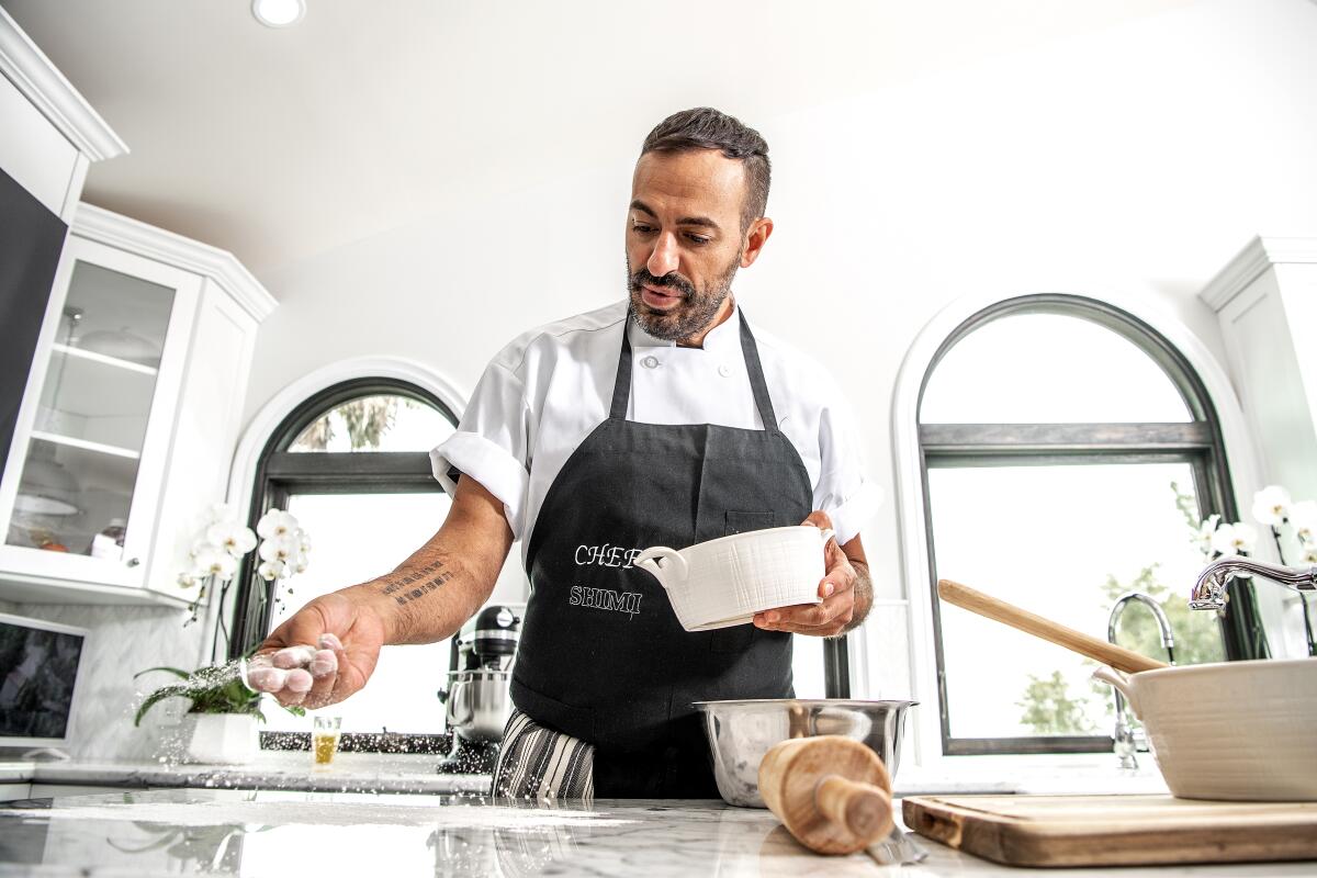 Chef and baker Shimi Aaron flouring a surface while making babkas.