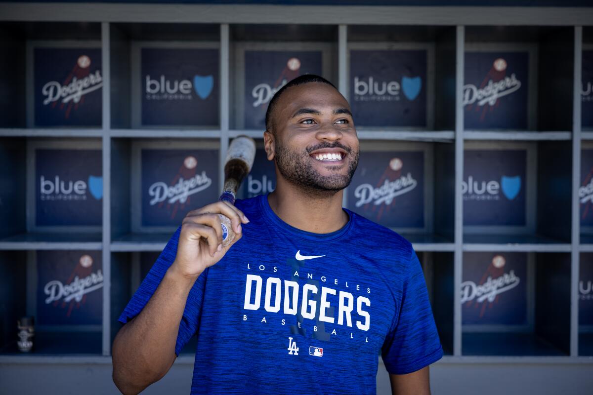 A man wearing a blue Dodgers t-shirt poses for a photo