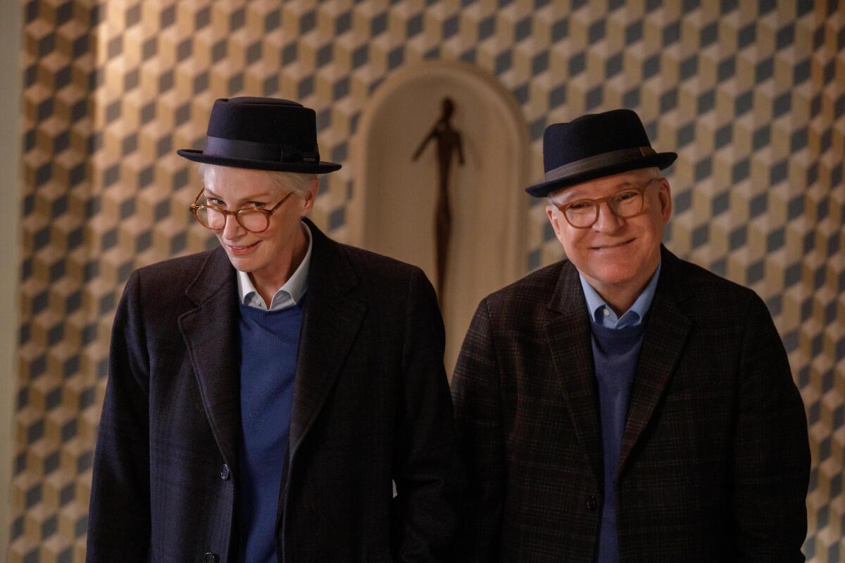 Two people dressed alike stand next to each other
