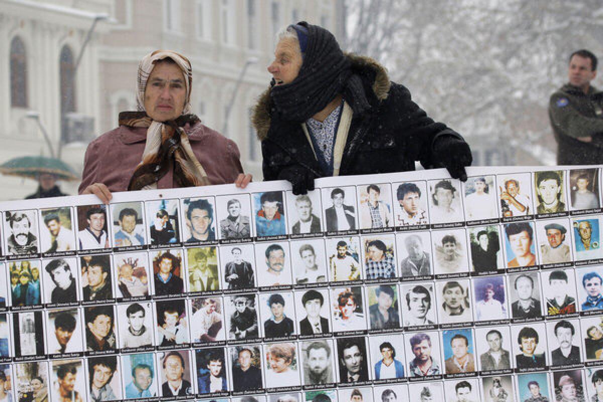 Survivors of the 1995 Srebrenica massacre hold photographs of male relatives who were killed in Europe's worst atrocity since World War II. The women staged their demonstration against Bosnian Serb commander Zdravko Tolimir in the northern Bosnian town of Tuzla on Tuesday, a day before the Yugoslav war crimes tribunal convicted him of genocide.