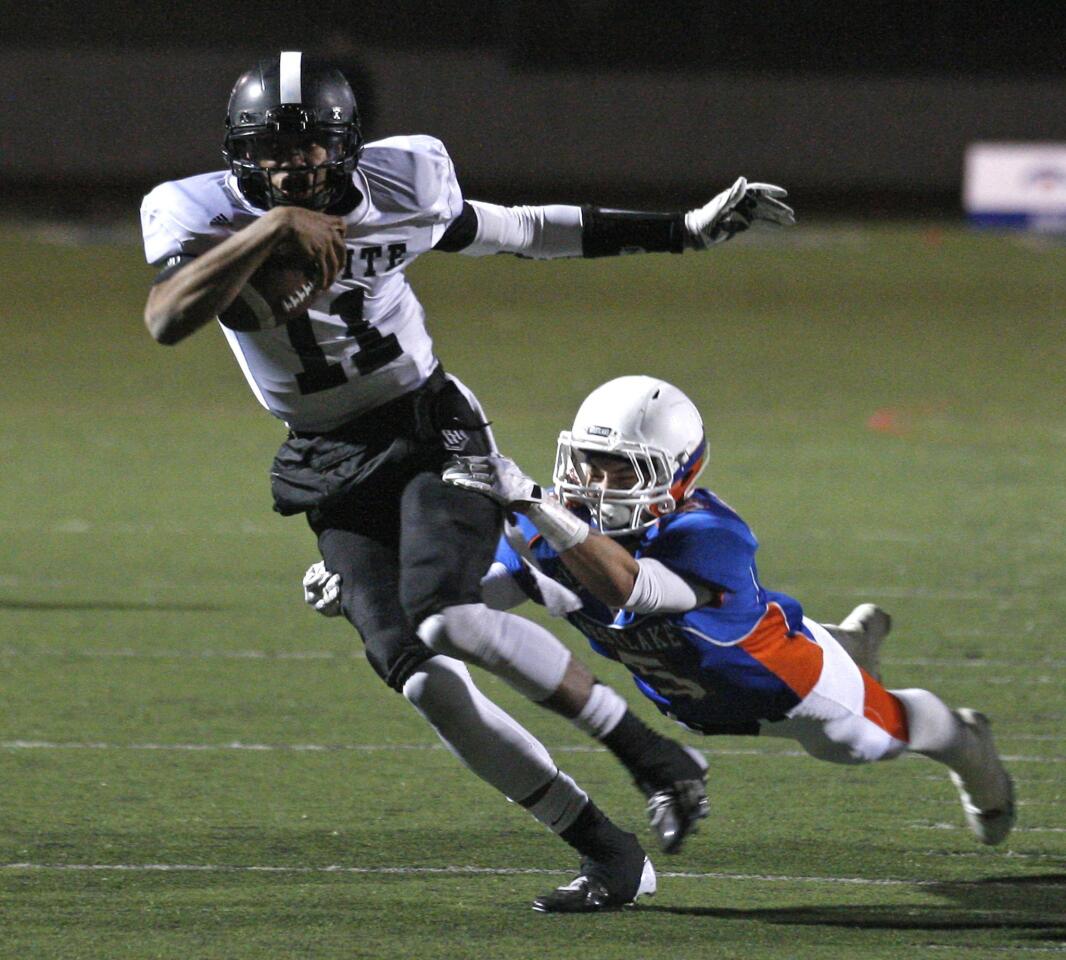 Servite quarterback Travis Waller breaks a tackle by diving Westlake defensive back Trenton Padilla during a Pac-5 Division first-round playoff game on Friday night.