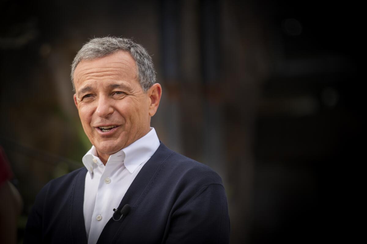 Disney Chief Executive Bob Iger, talks while wearing a white shirt and dark jacket.