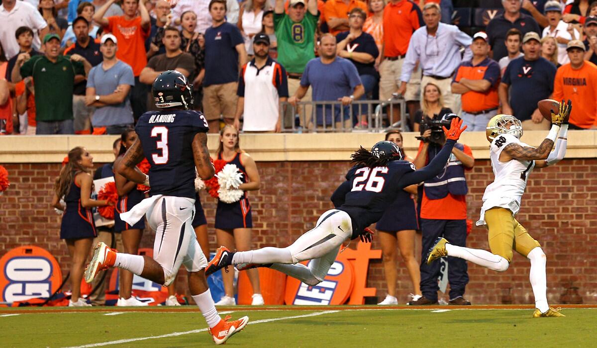 Notre Dame wide receiver William Fuller catches the game-winning touchdown pass in front of Virginia cornerback Maurice Canady in the fourth quarter on Saturday.