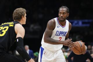 Los Angeles Clippers forward Kawhi Leonard, right, looks past Utah Jazz forward Lauri Markkanen during the first half of a preseason NBA basketball game Tuesday, Oct. 10, 2023, in Seattle. (AP Photo/Lindsey Wasson)