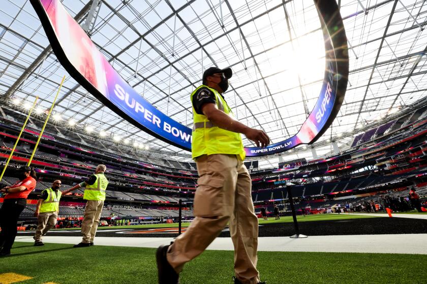 Inglewood, CA - February 13: Security walks the field before the start ofSuper Bowl LVI at SoFi Stadium on Sunday, Feb. 13, 2022 in Inglewood, CA.(Robert Gauthier / Los Angeles Times)
