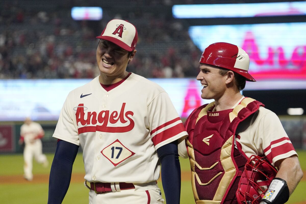 Los Angeles Angels starting pitcher Shohei Ohtani, left, talks with catcher Max Stassi after the eighth inning of a baseball game against the Oakland Athletics Thursday, Sept. 29, 2022, in Anaheim, Calif. (AP Photo/Mark J. Terrill)