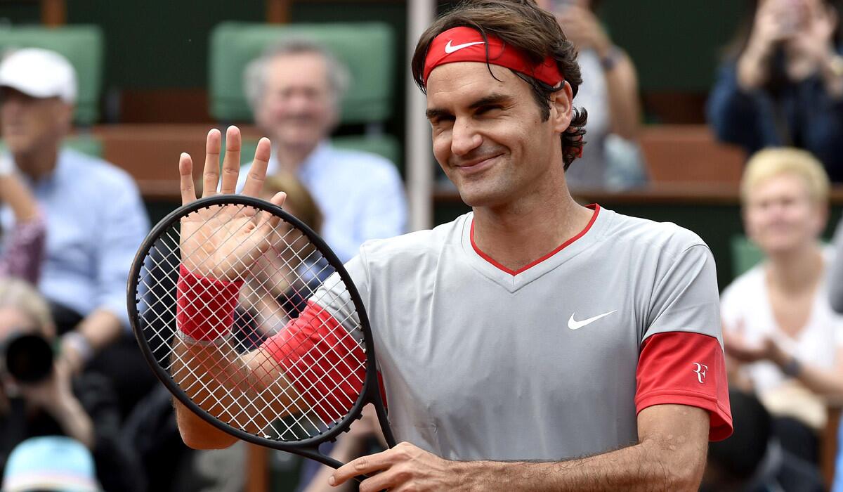 Roger Federer waves at the crowd after winning his first-round match at the French Open on Sunday.