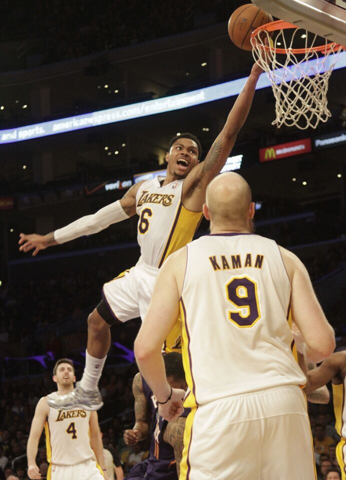 Lakers guard Kent Bazemore shoots a lay-up as teammate Chris Kaman looks on during the Lakers' 115-99 victory over the Phoenix Suns at Staples Center on Sunday.