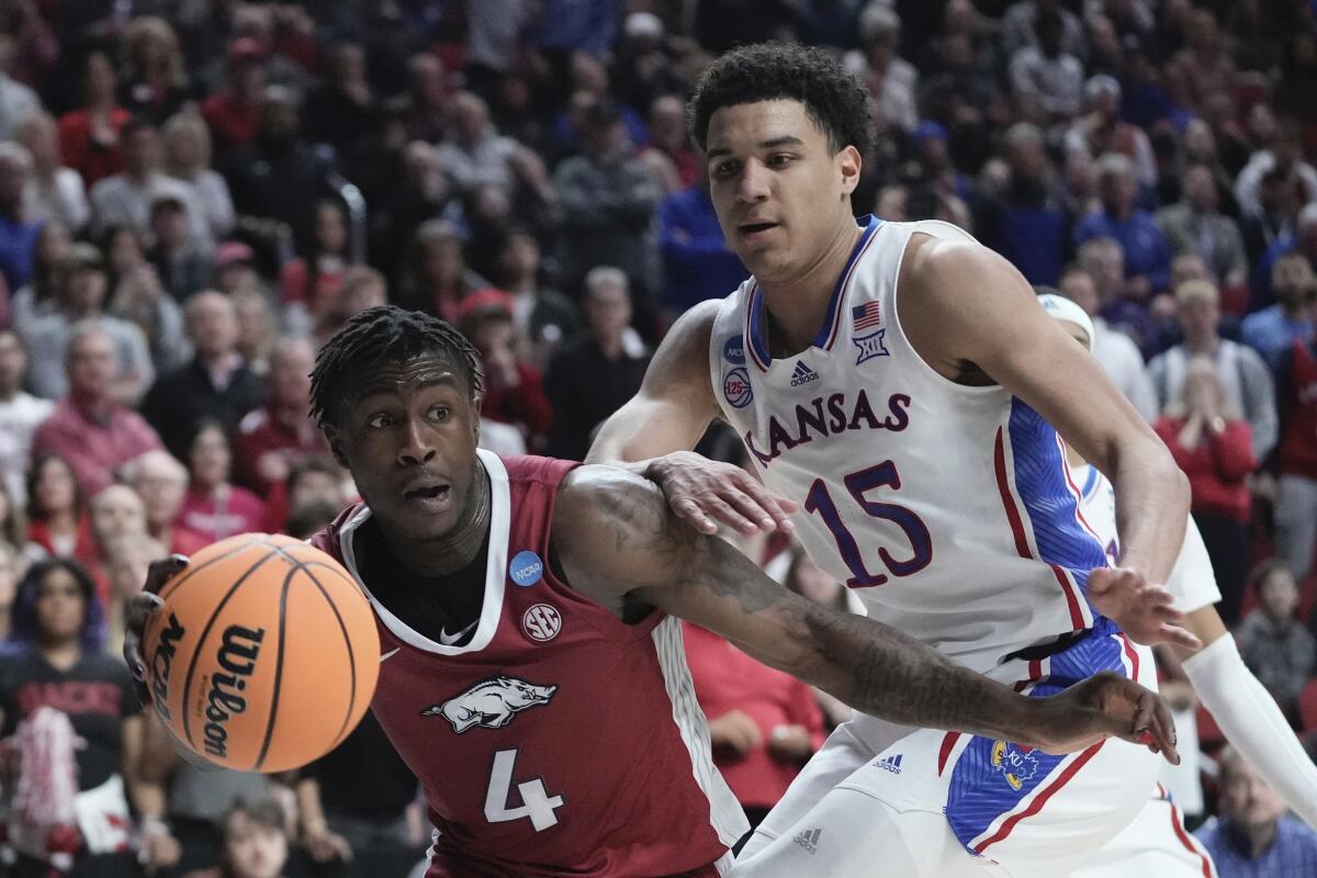 Arkansas' Davonte Davis drives past Kansas' Kevin McCullar Jr. in the NCAA tournament March 18, 2023.